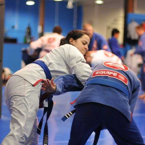 Gracie Jiu-Jitsu athletes practicing on mat.