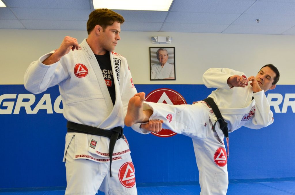 BJJ practitioners demonstrate a move at Gracie Barra Brazilian Jiu-Jitsu