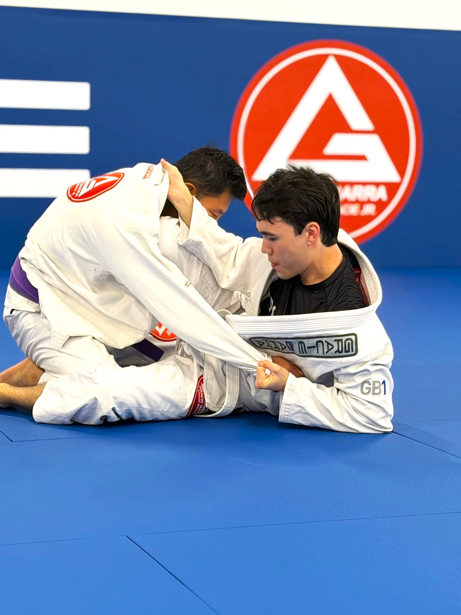 Beginner student practicing a Brazilian Jiu-Jitsu technique at Gracie Barra Artarmon