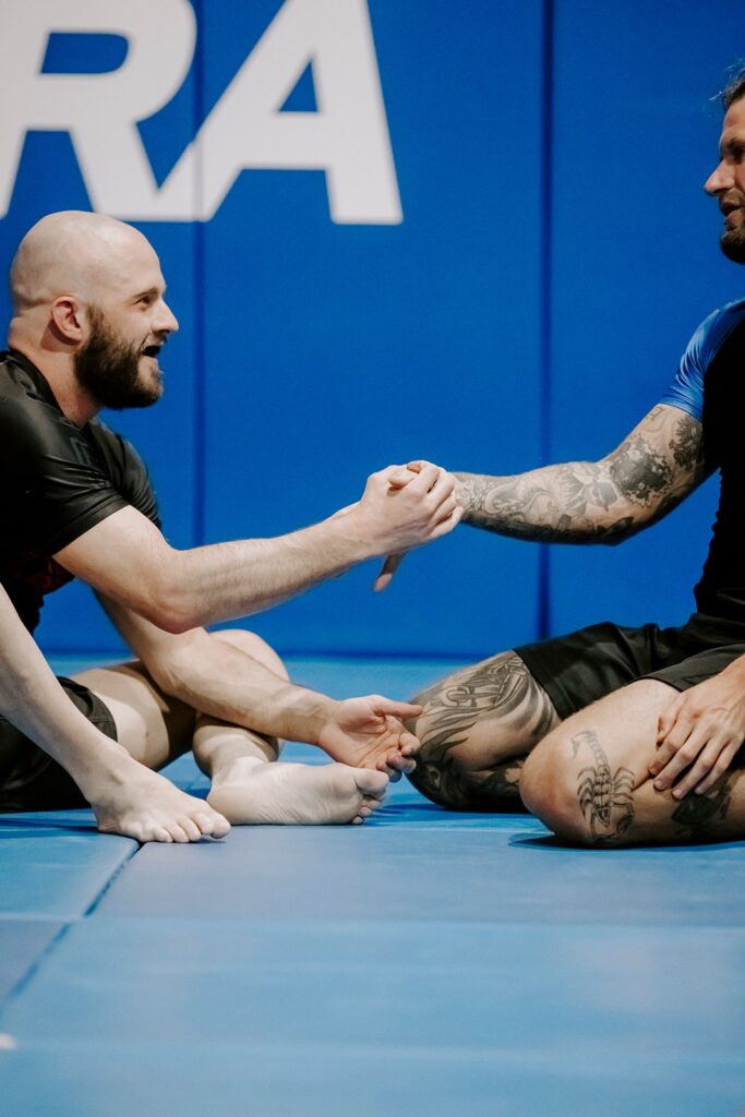 Two advanced No-Gi BJJ students shaking hands before sparring at GB Erina